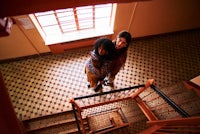 a woman is hugging another woman on a staircase