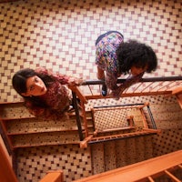 two women standing on a staircase